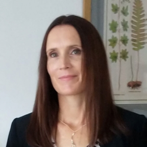 Headshot of smiling woman with brown hair