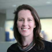 Caroline_CorpResponsibility-1-523×705 headshot of smiling brown haired woman in black