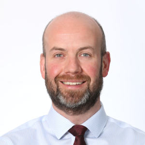 Headshot of smiling man with beard