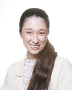 Smiling woman with long brown ponytail
